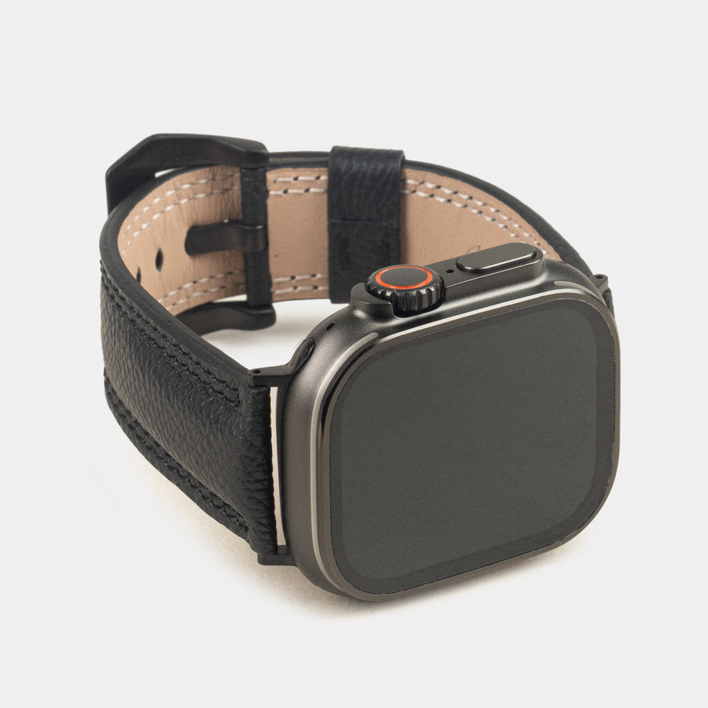 Apple Watch Ultra bandje heren 49 mm zwart Epsom leer met zwarte gespen — driekwart vooraanzicht met de wijzerplaat van de Ultra, de gesp en de leren lus