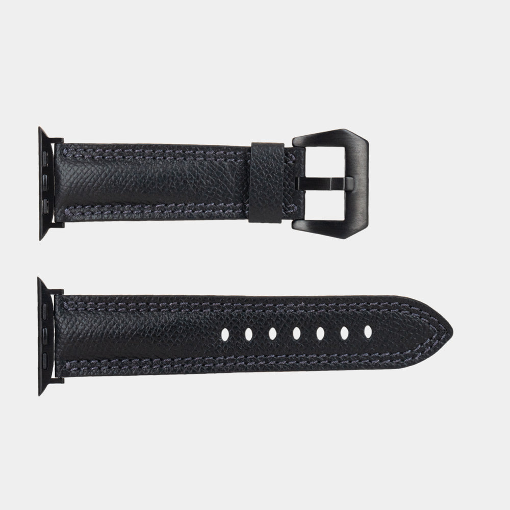 Apple Watch Ultra bandje heren 49 mm zwart Epsom leer — plat gelegd, beide banddelen met hun zwarte bevestigingen en zwarte gesp
