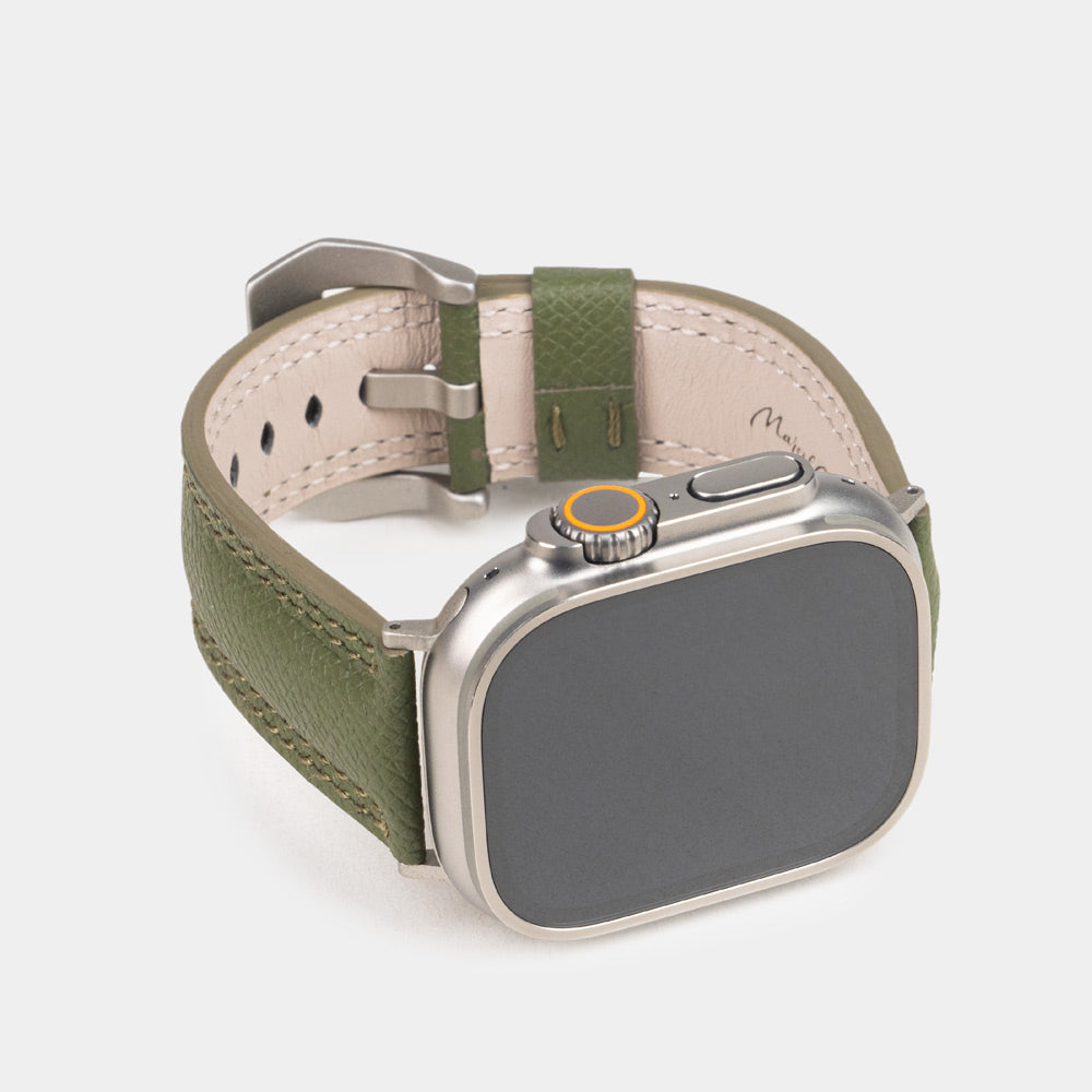 Apple Watch Ultra bandje heren 49 mm kakigroen Epsom leer met titanium gespen — driekwart vooraanzicht met de wijzerplaat van de Ultra, de gesp en de leren lus
