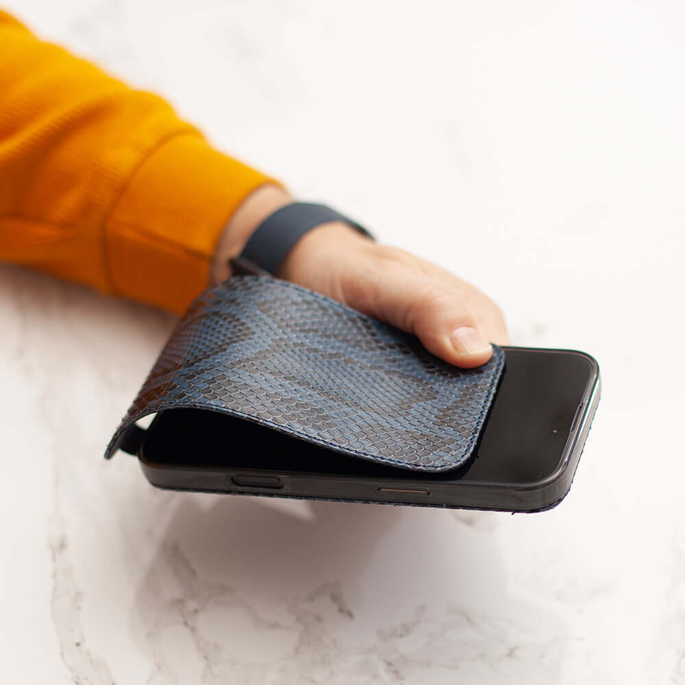 Hand holding iPhone with iPhone 17 Pro Max Python Blue Leather Case, showcasing its stylish design and texture.