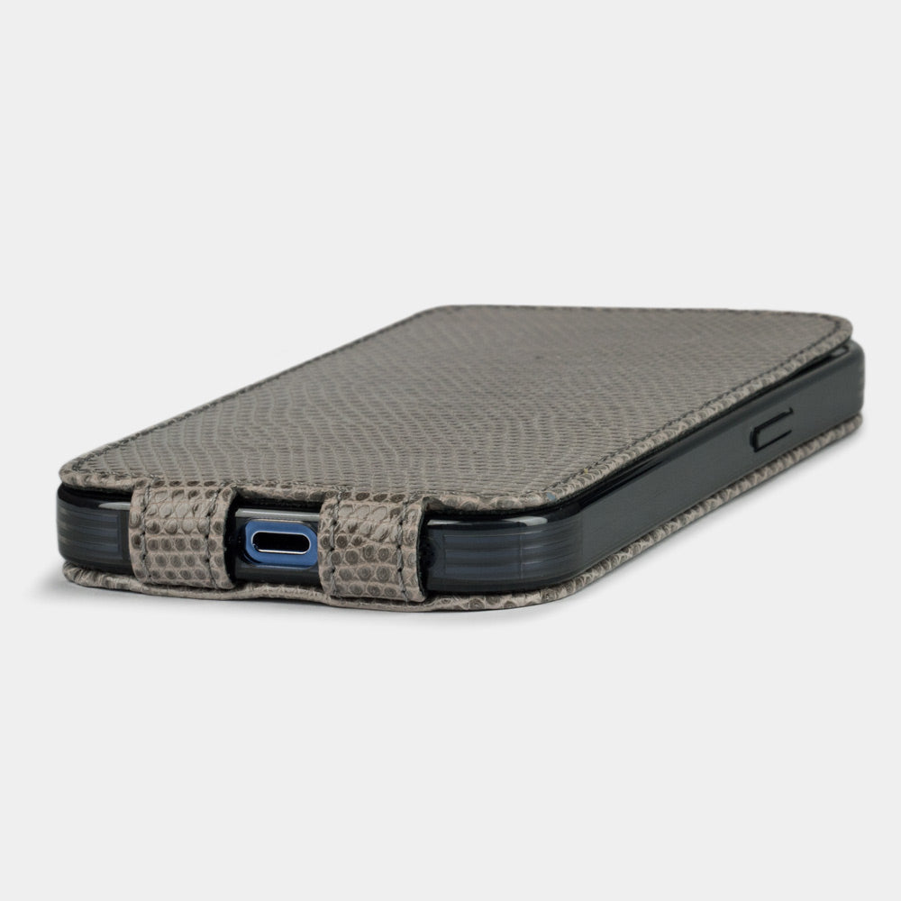 iPhone 14 Pro flip case in grey lizard leather – the case laid flat, showing the precise charging-port cut-out and slim profile