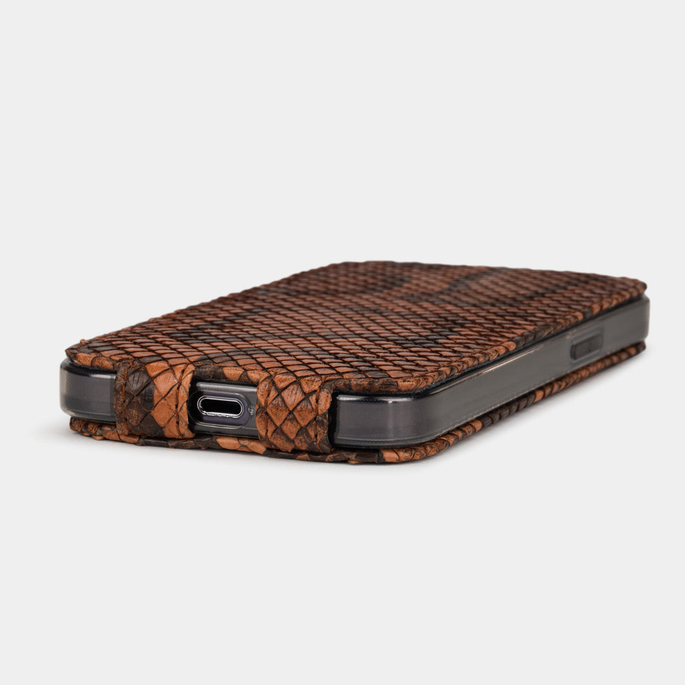 iPhone 14 Pro seated in the gold python leather case, flip cover open