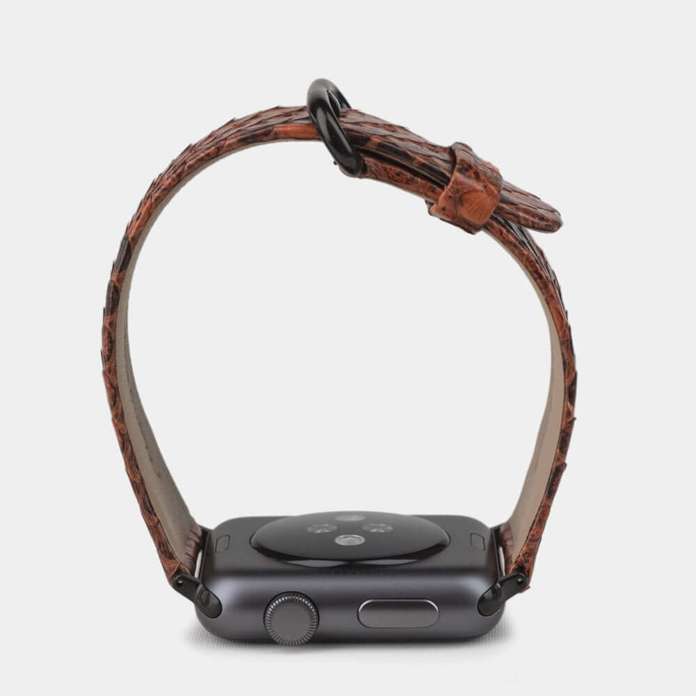 gold python strap apple watch with black adapters and buckle profile view