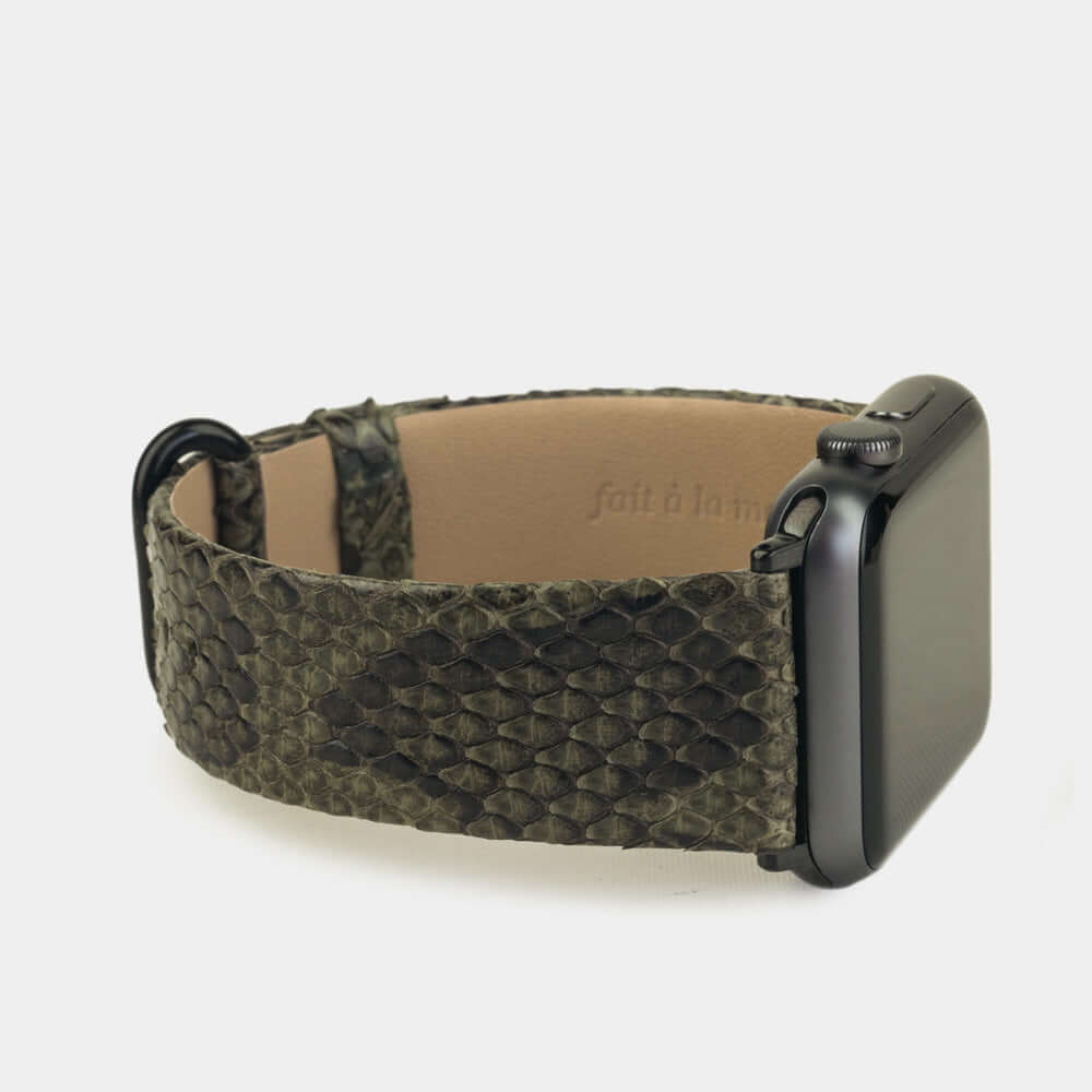 green python strap apple watch with black adapters and buckle side view