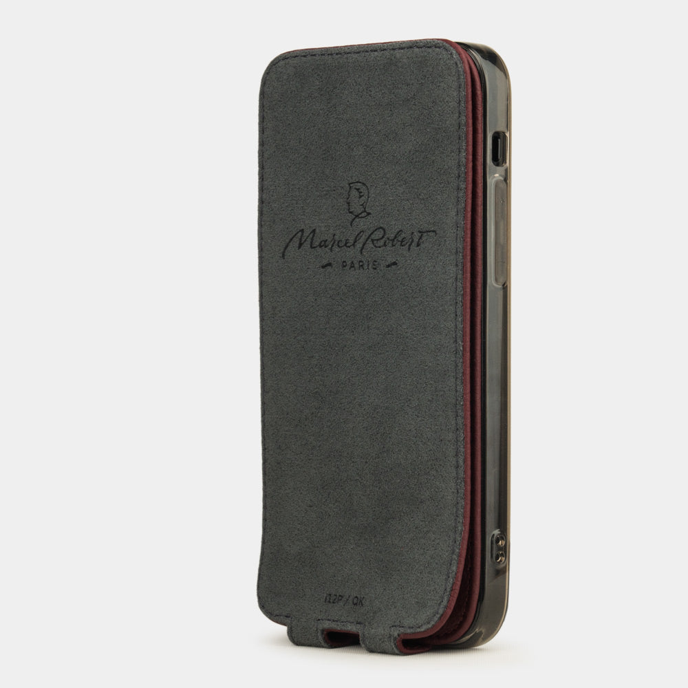 bordeaux leather flip case for iPhone 12 Pro, vertical position, cover folded and secured to the back of the iPhone thanks to its integrated magnet system, revealing the grey microfiber lining