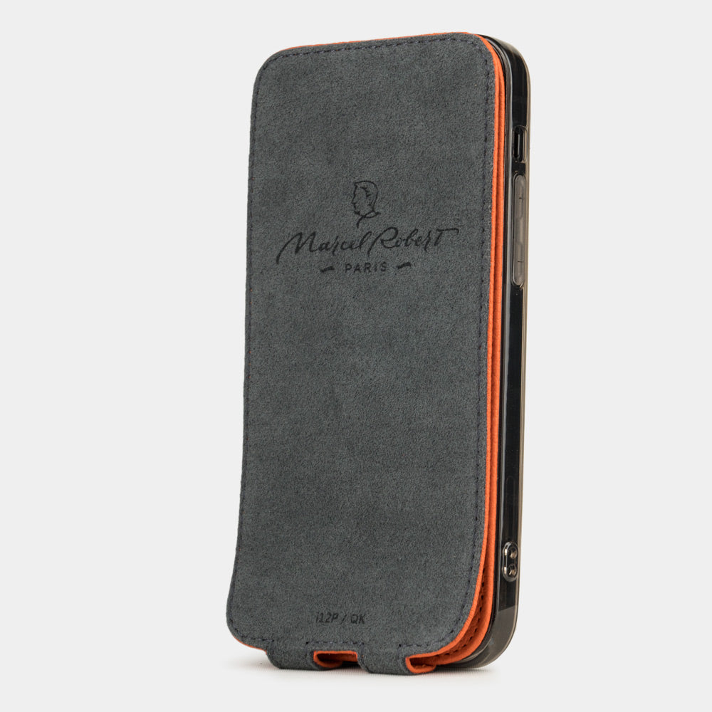 orange leather flip case for iPhone 12 pro max, vertical position, cover folded and secured to the back of the iPhone thanks to its integrated magnet system, revealing the grey microfiber lining