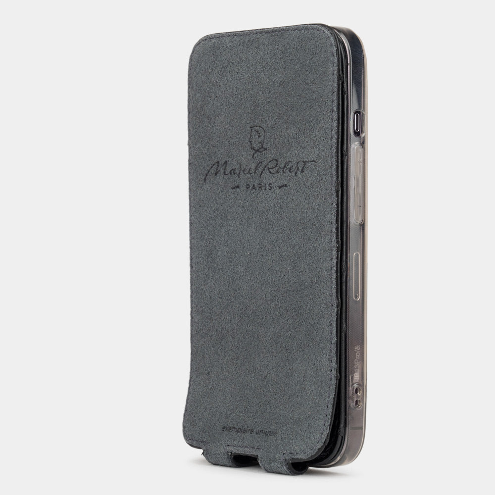 black ostrich leather flip case for iPhone 13 mini, vertical position, cover folded and secured to the back of the iPhone thanks to its integrated magnet system, revealing the grey microfibre lining
