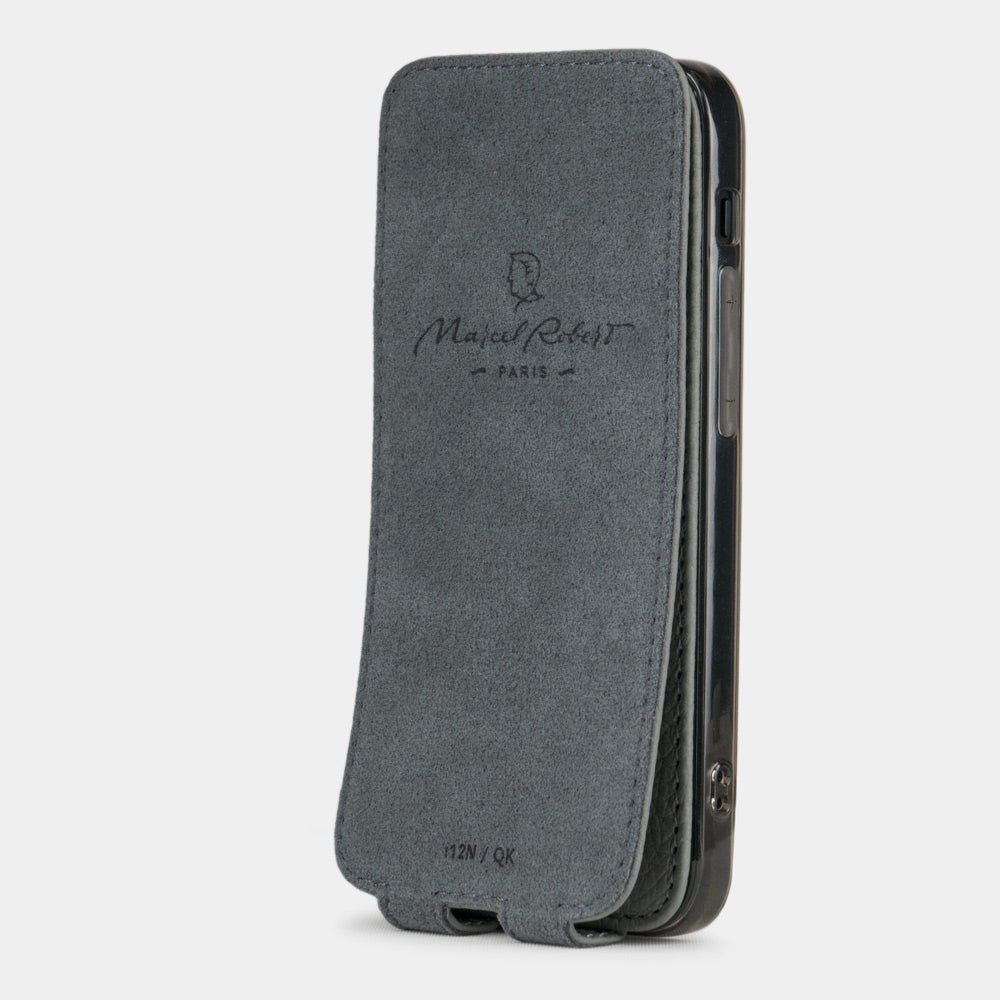 gray leather flip case for iPhone 12 pro, vertical position, cover folded and secured to the back of the iPhone thanks to its integrated magnet system, revealing the grey microfiber lining
