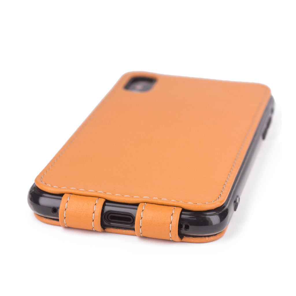 Ocre leather flip case for iPhone X - close-up of the bottom edge showing the Lightning port opening