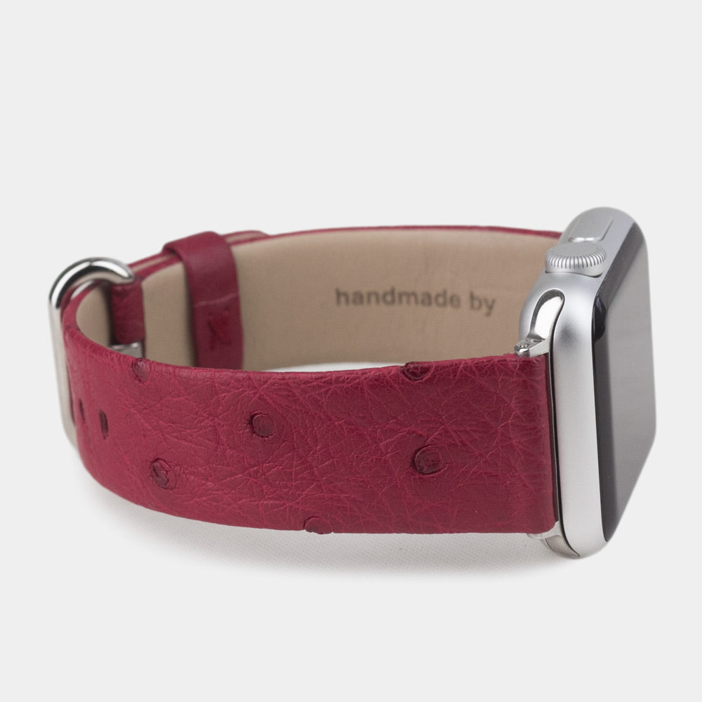 Strap for the Apple Watch 41/42 mm in fuchsia ostrich leather, with steel adapters and buckle | front view of the strap looped around the watch case