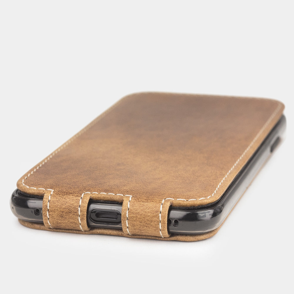 vintage leather flip case for iPhone X - close-up of the bottom edge showing the Lightning port opening