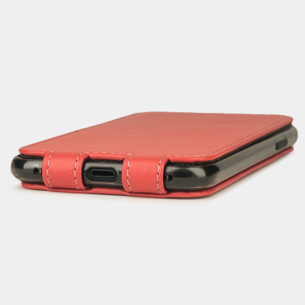 Red Coral leather flip case for iPhone X - close-up of the bottom edge showing the Lightning port opening