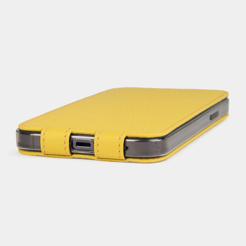 Yellow calfskin leather flip case for iPhone 15 – bottom view with USB-C port opening and hand-stitched edges