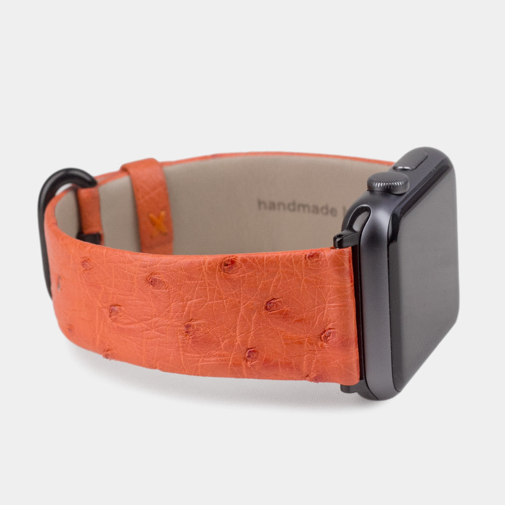 Strap for the Apple Watch 41/42 mm in orange ostrich leather, with black adapters and buckle | 3/4 profile view to see the inner lining leather