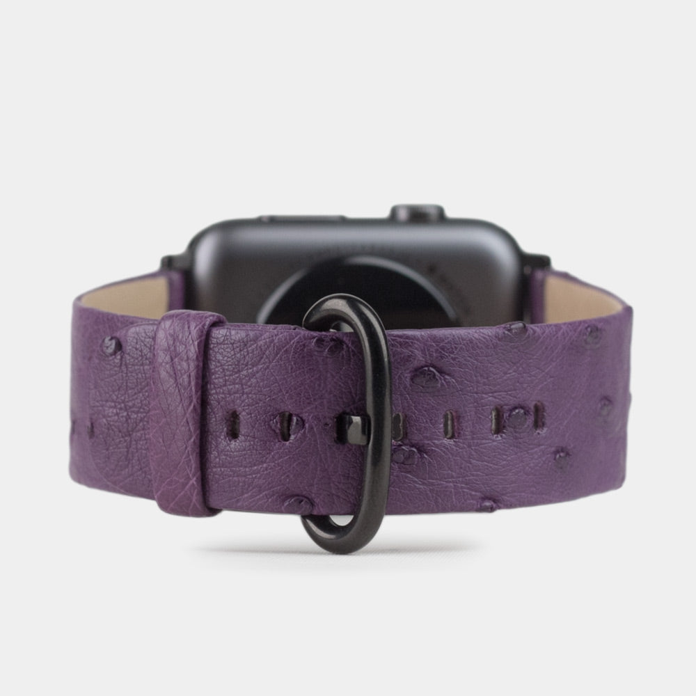 Strap for the Apple Watch 41/42 mm in purple ostrich leather, with black adapters and buckle | watch case on bottom to see leather texture, inner lining and the buckle