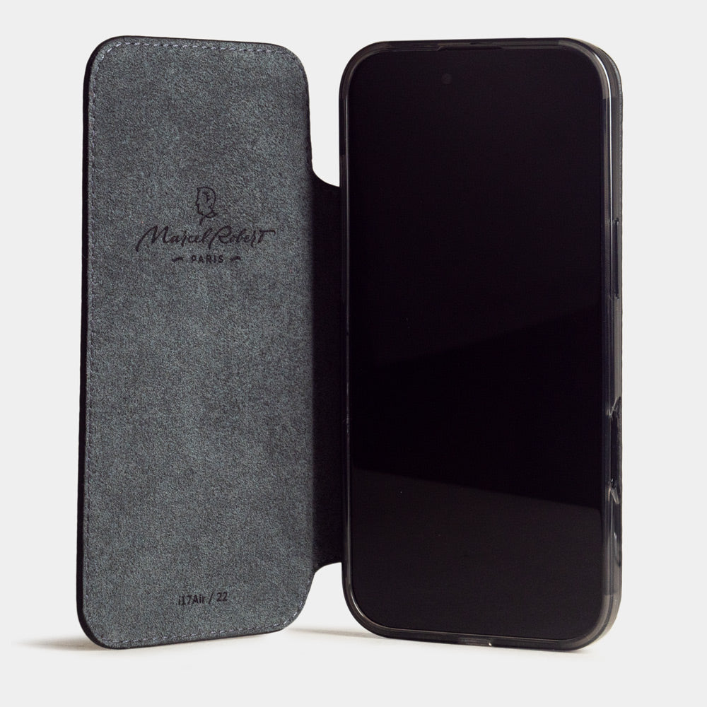 iPhone 17e & 16e calfskin folio wallet case black – case with grey Alcantara lining, shown open on the smartphone
