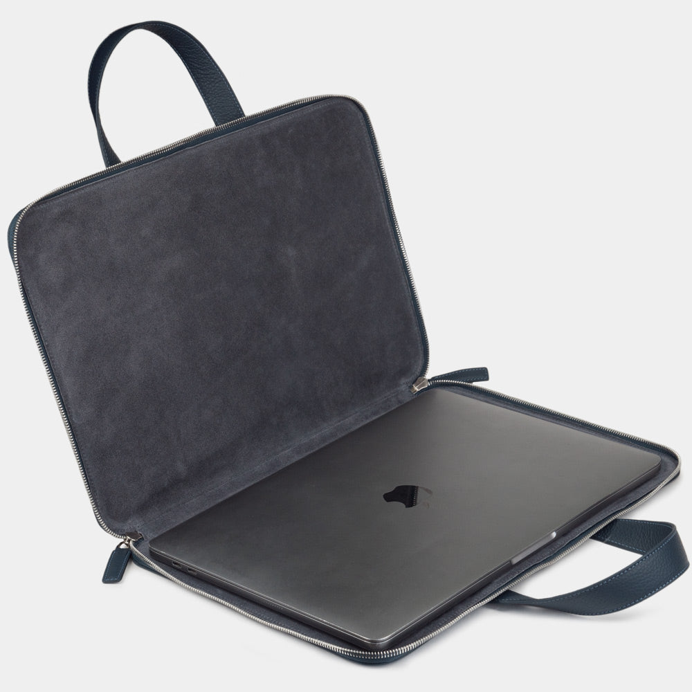 Blue men’s 17 inch leather laptop bag with pockets open showing laptop compartment and interior lining