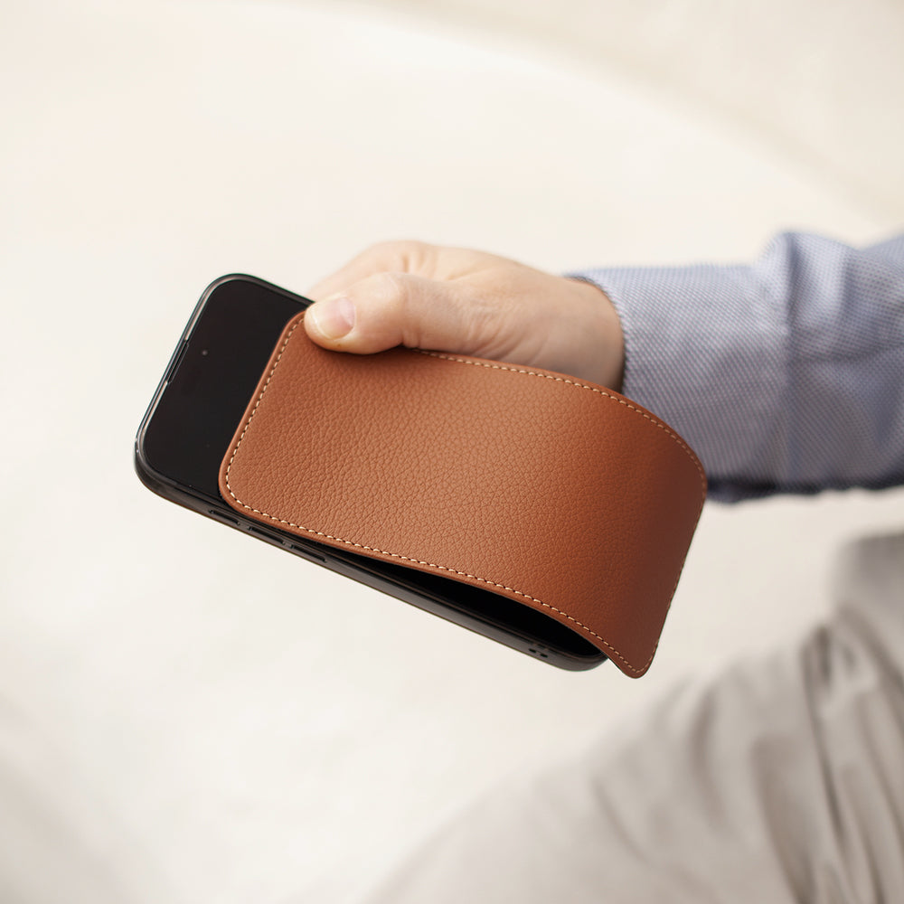 Contextual photo of Marcel Robert iPhone 17 pro Max gold calfskin leather case, held in hand with magnetic front cover partially open