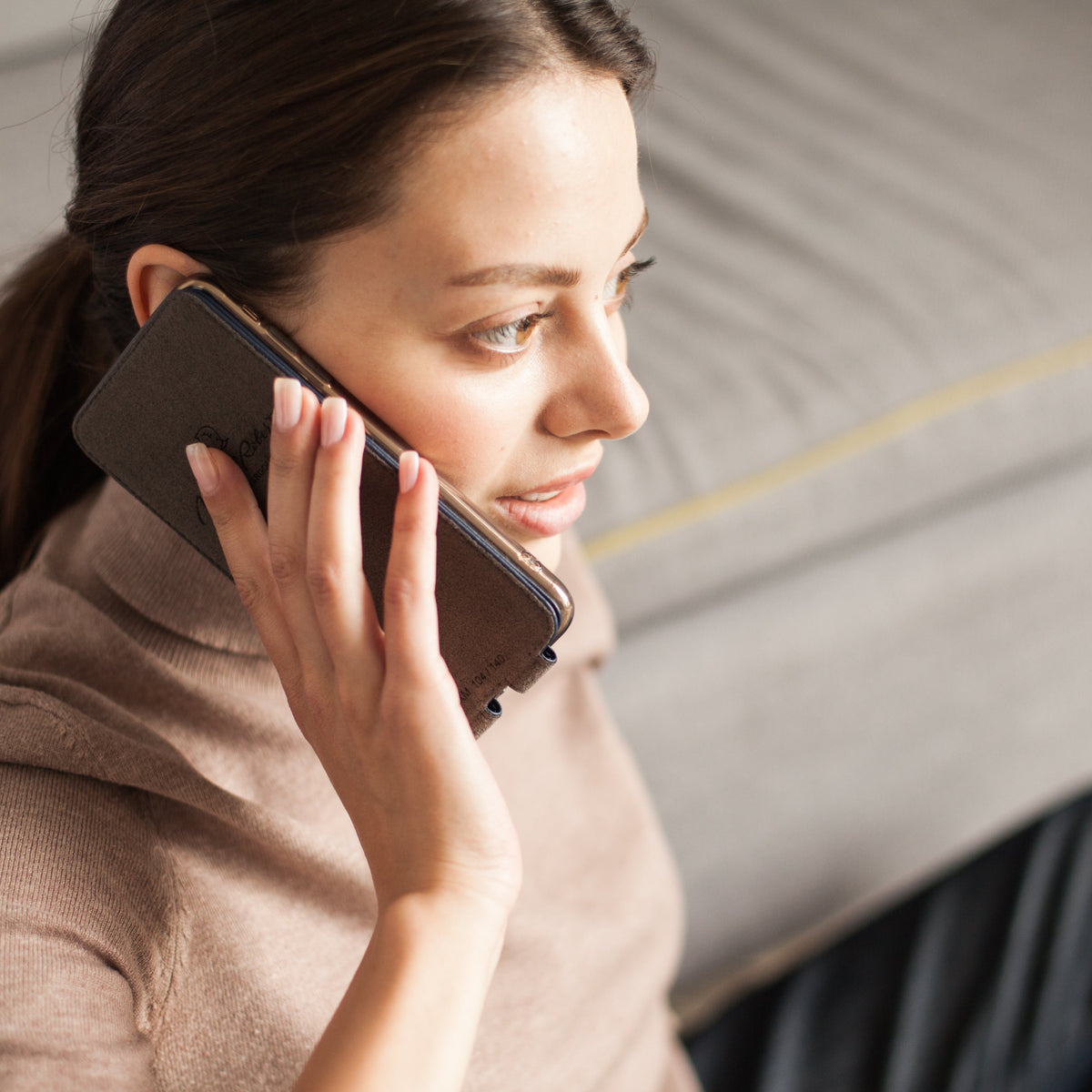 iPhone 14 Pro Max flip case made with blue premium leather – lifestyle photo: the soft flap folds back behind the phone for a call