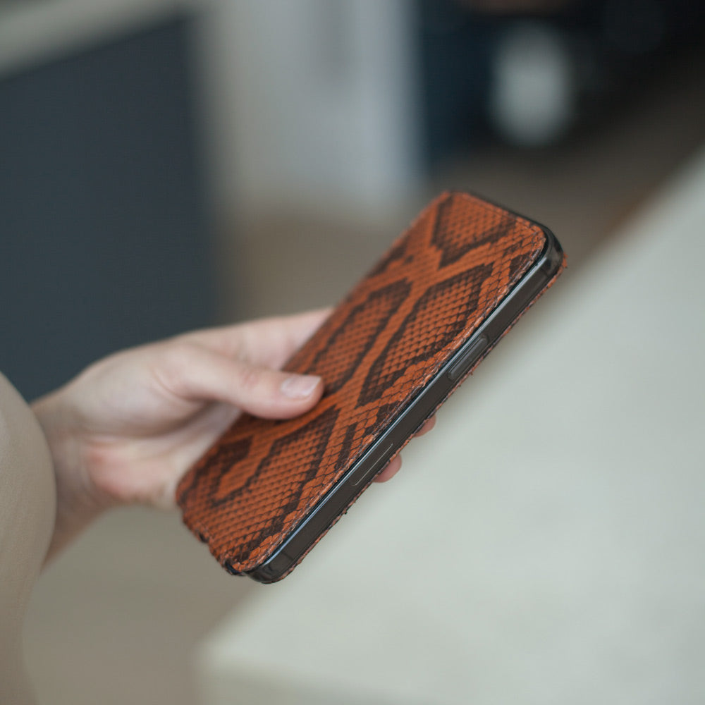 Close-up of the gold python leather grain on the Marcel Robert iPhone 14 Pro case