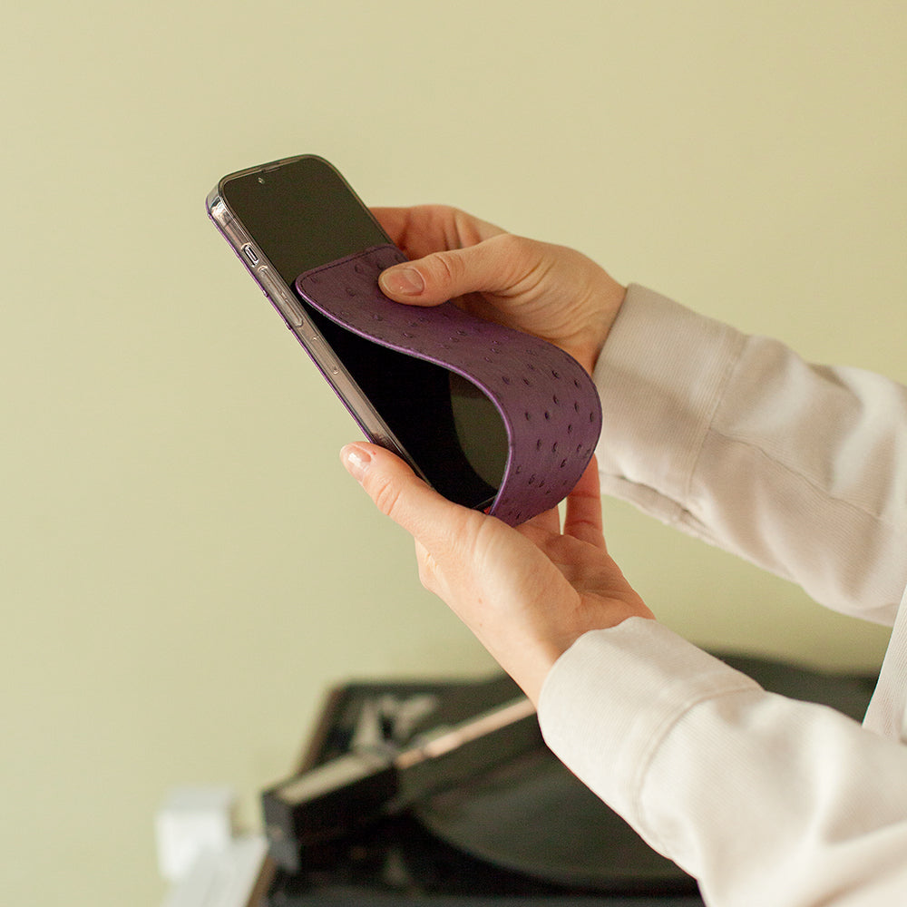 Opening Marcel Robert purple ostrich leather iPhone 13 Pro case showing the supple flexible flap