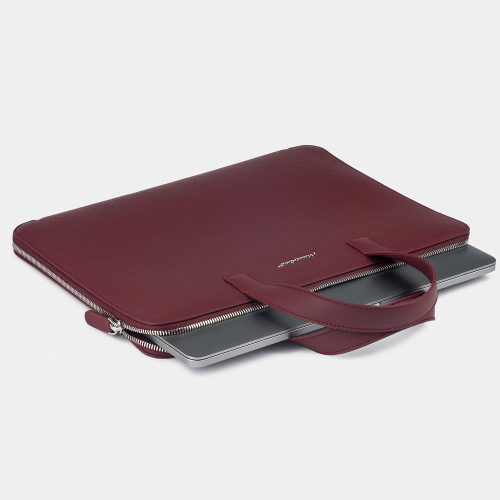 Slim 17 inch bordeaux leather laptop bag holding laptop, structured minimalist design