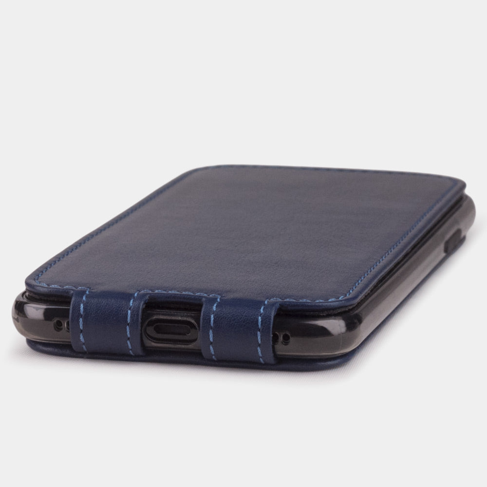 Blue Indigo leather flip case for iPhone X - close-up of the bottom edge showing the Lightning port opening