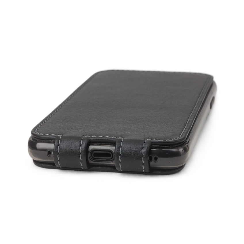 Black leather case for iPhone X - close-up of the bottom edge showing the Lightning port opening
