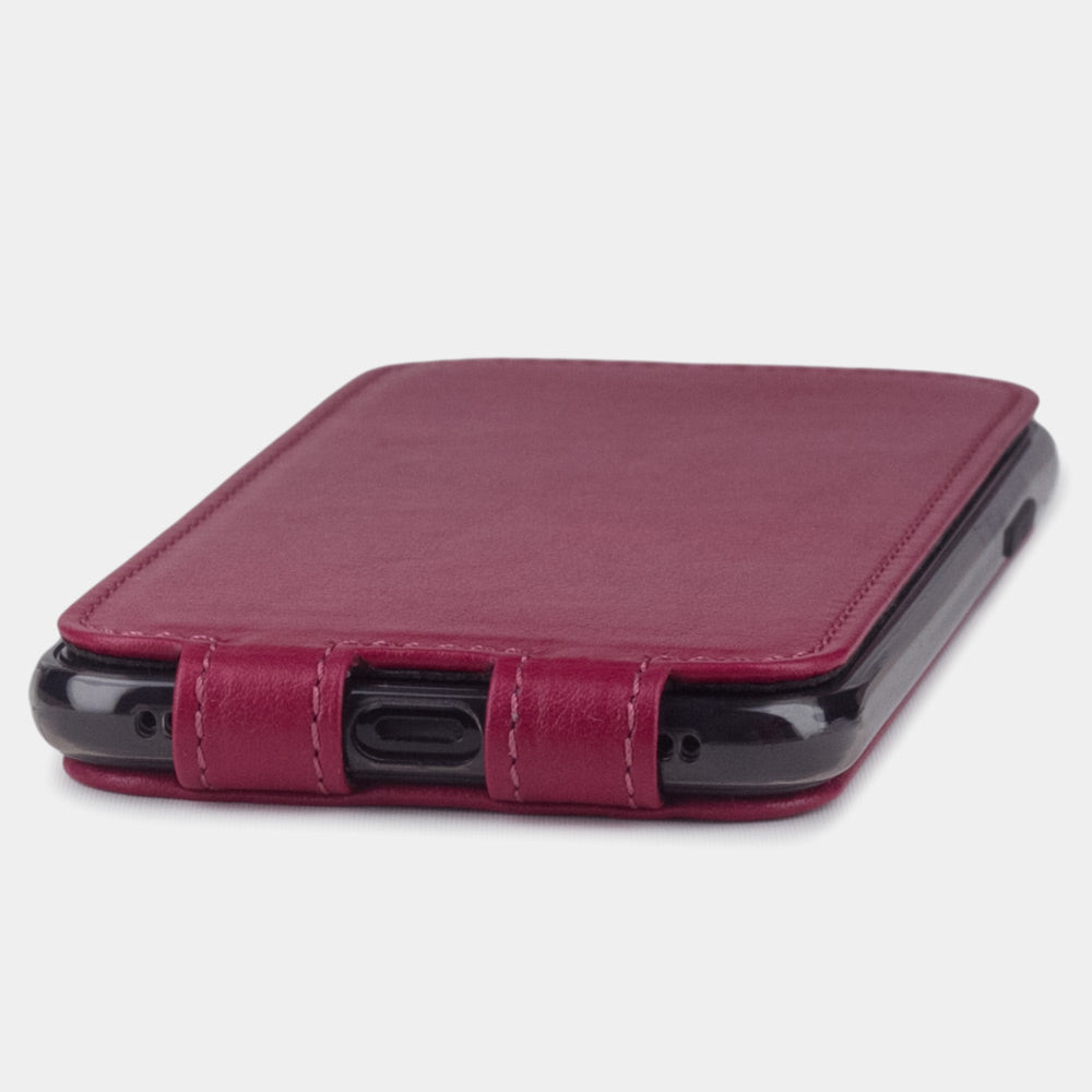 Fuchsia leather flip case for iPhone X - close-up of the bottom edge showing the Lightning port opening