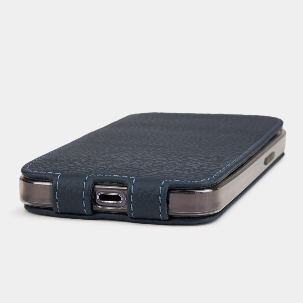 Blue calfskin leather flip case for iPhone 15 – bottom view with USB-C port opening and hand-stitched edges
