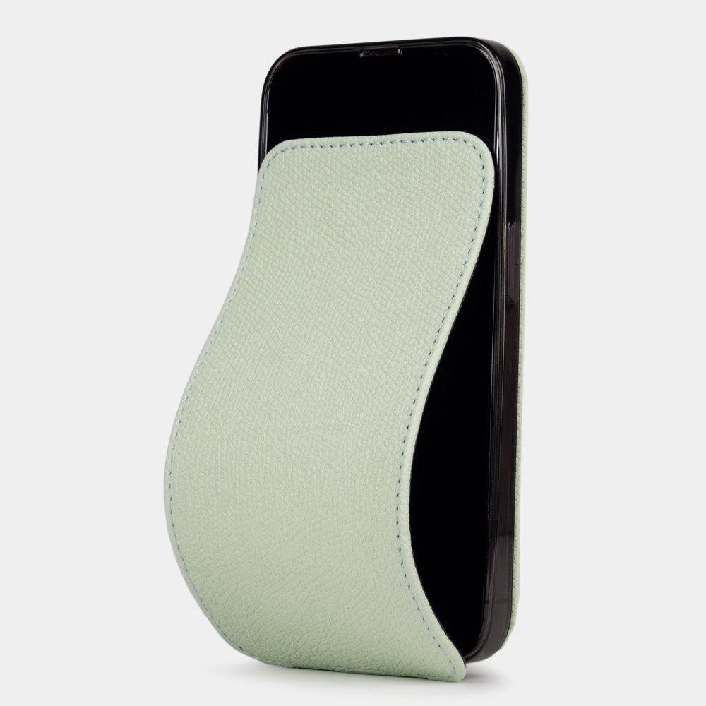Pastel green calfskin leather flip case for iPhone 15 – folding magnetic flap curving away to clean the screen