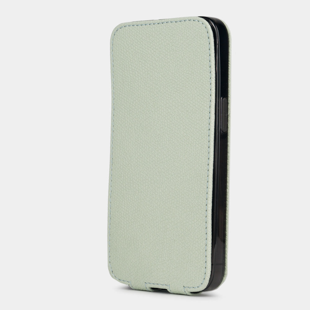 Pastel green calfskin leather flip case for iPhone 15 – flap closed flat, profile view with side buttons accessible