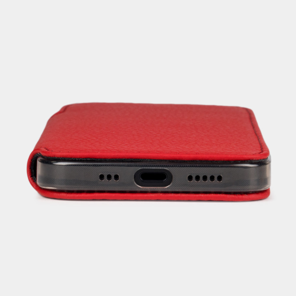 Red calfskin leather folio case for iPhone 15 Pro – bottom edge with the port opening and speaker cutouts
