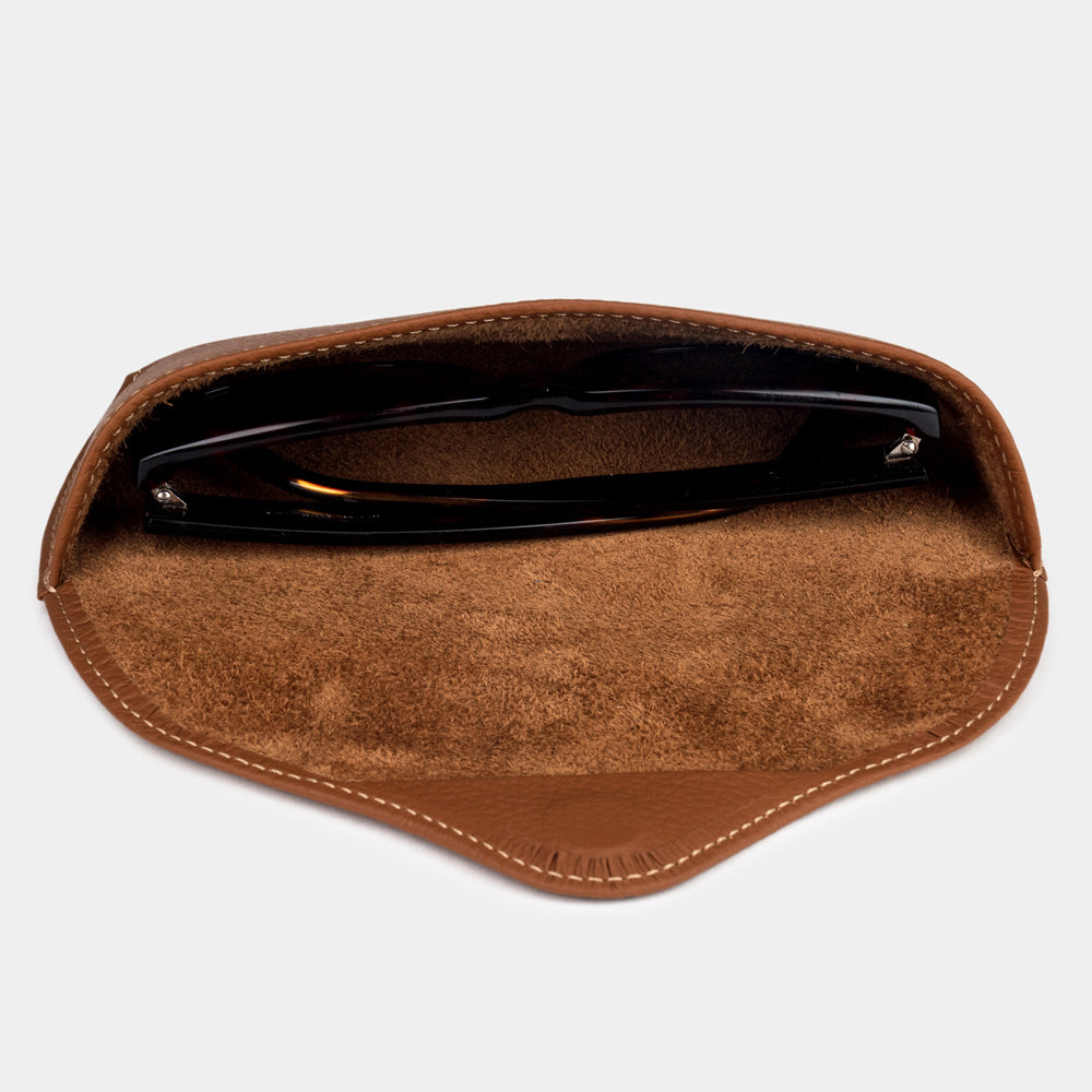 Gold calfskin Riviera case seen from above, sunglasses resting on the suede