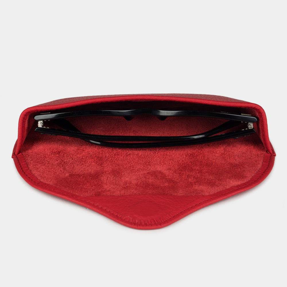 Red calfskin Riviera case seen from above, sunglasses resting on the suede