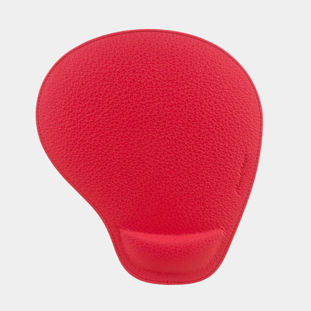 Tappetino mouse in pelle rosso visto dall'alto, forma a goccia e firma impressa