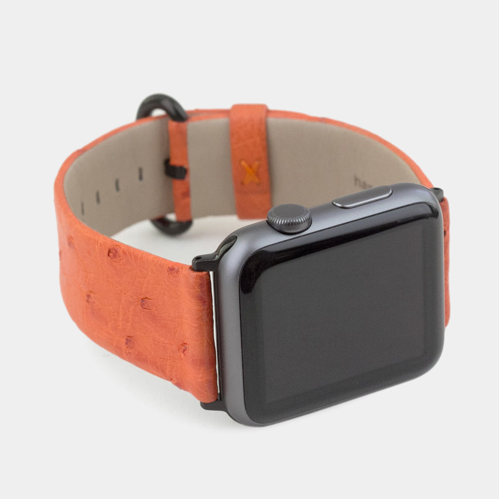 Strap for the Apple Watch 41/42 mm in orange ostrich leather, with black adapters and buckle | close-up on the inner lining leather and the brand stamp